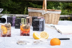 A sunny outdoor picnic with colorful juice-filled cups.