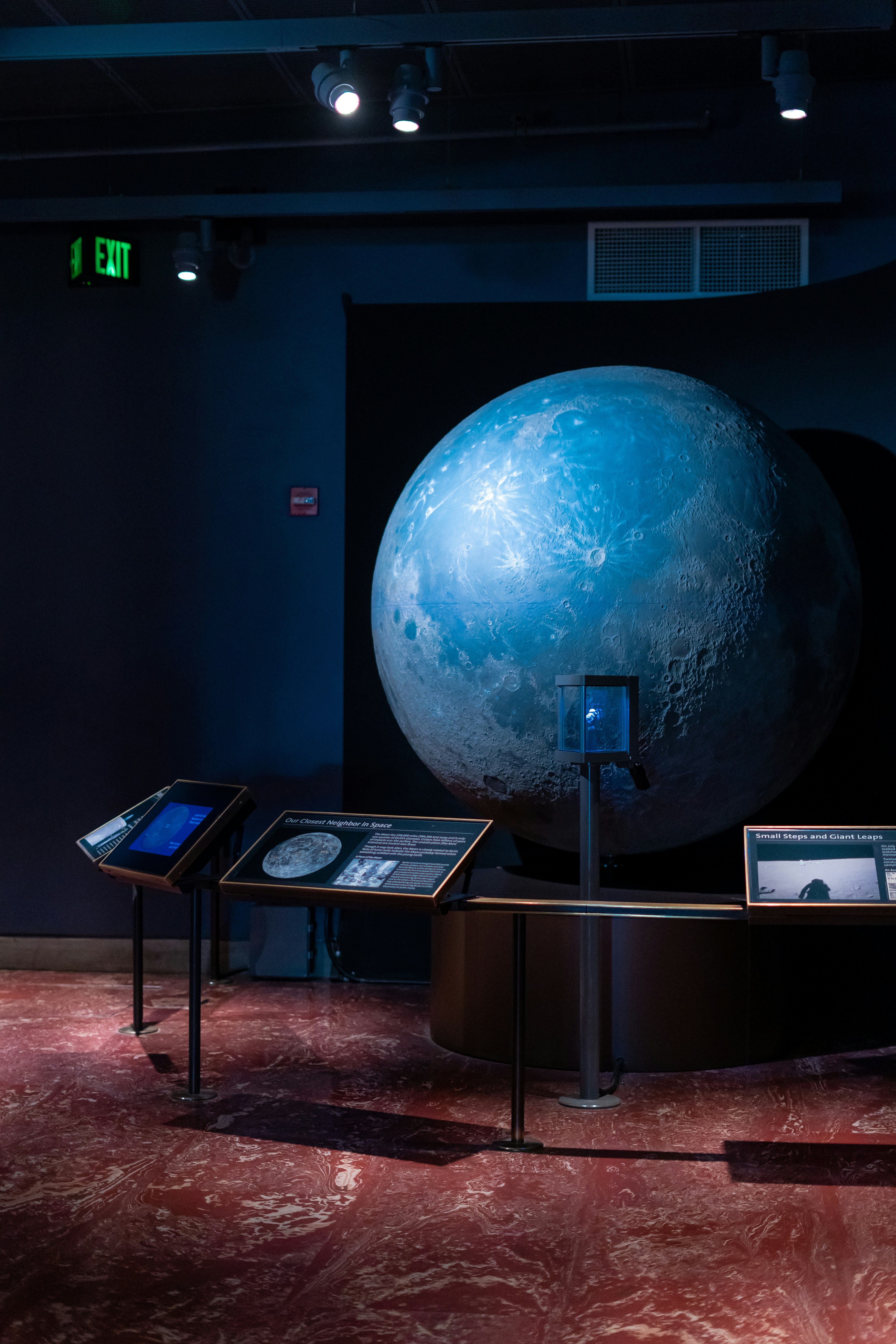 a museum display with a large blue ball