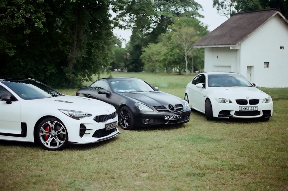 a couple of cars parked next to each other in a field