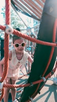 Cute children wearing Suntwisters sunglasses playing outdoors