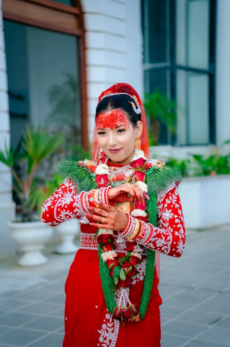 A woman wearing colorful traditional Eastern attire standing outdoors