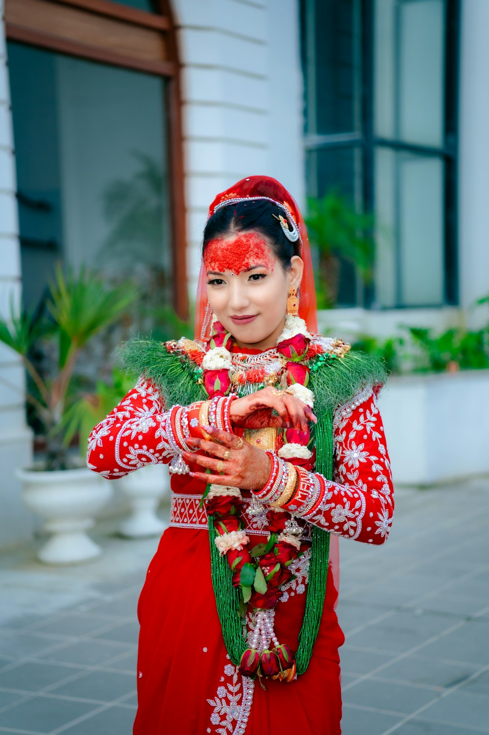 a young girl dressed in a red and green outfit