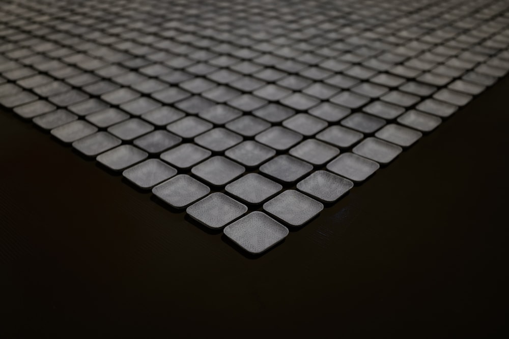 a close up of a black surface with squares