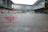 A glass window with a frosted design displays text and a logo in red, with the words 'China Art Museum Shanghai' visible. The background shows an outdoor view of modern architectural structures, slightly blurred.