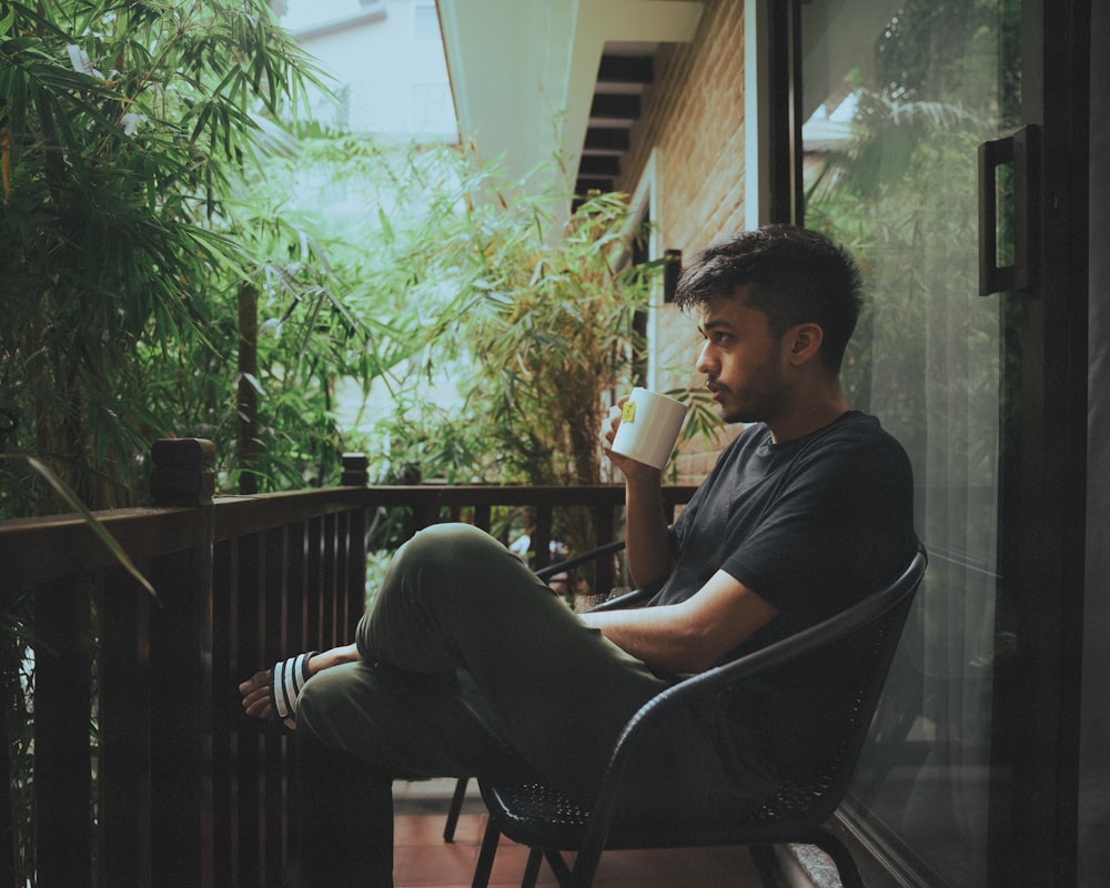 a man sitting in a chair on a porch