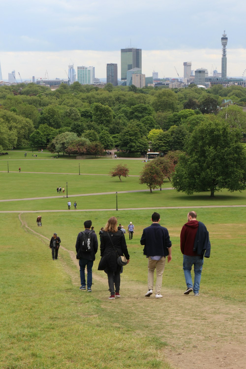 a group of people walking in a park