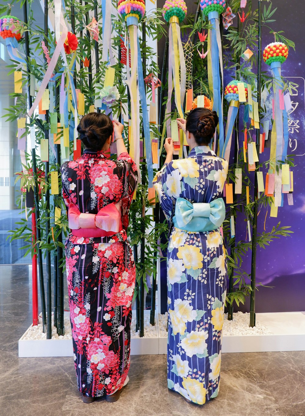 a couple of women standing next to each other