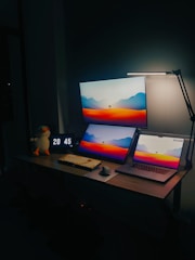 a desk with two laptops and a monitor on it
