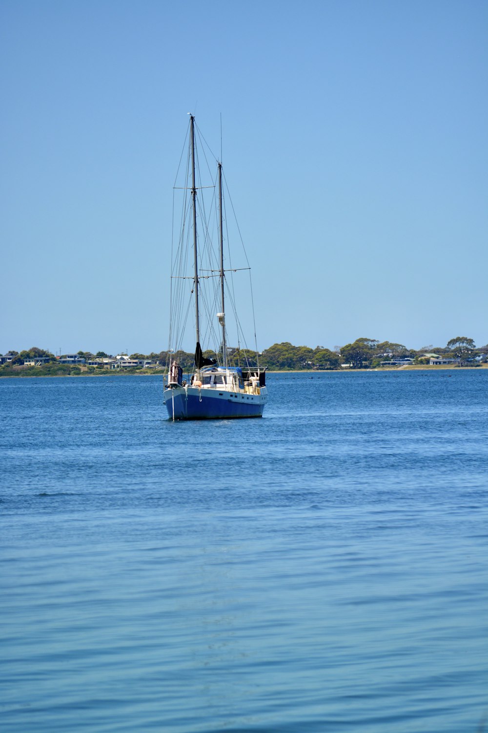 a sailboat floating in the middle of a body of water