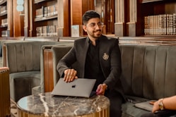 a man sitting at a table with a laptop