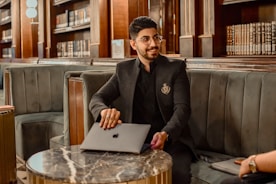 a man sitting at a table with a laptop