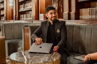 a man sitting at a table with a laptop