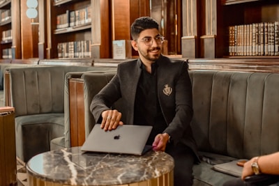 a man sitting at a table with a laptop