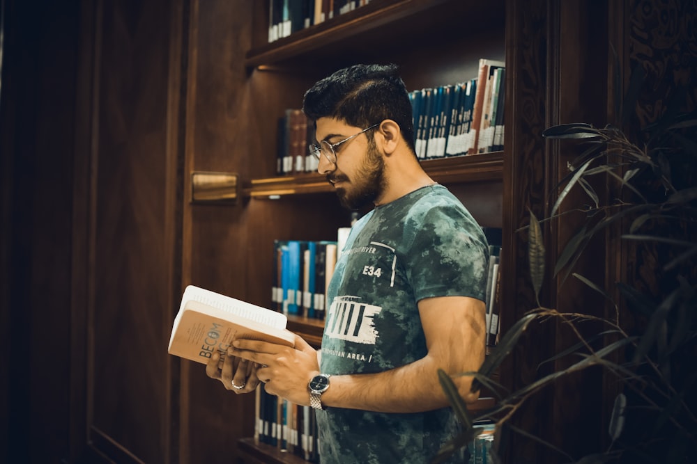 a man reading a book in a library