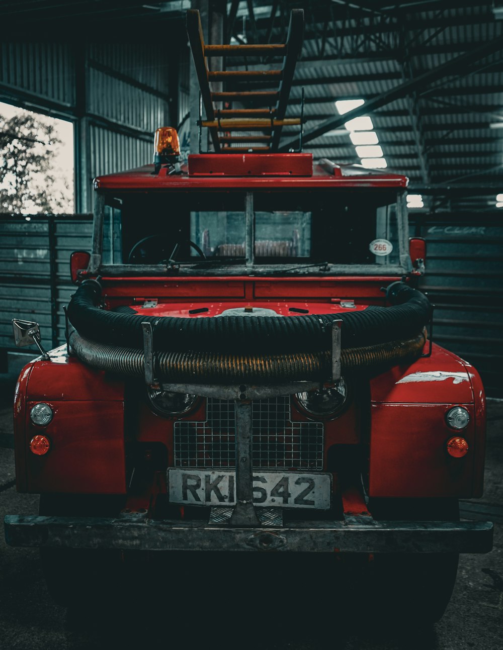 a red fire truck parked inside of a building