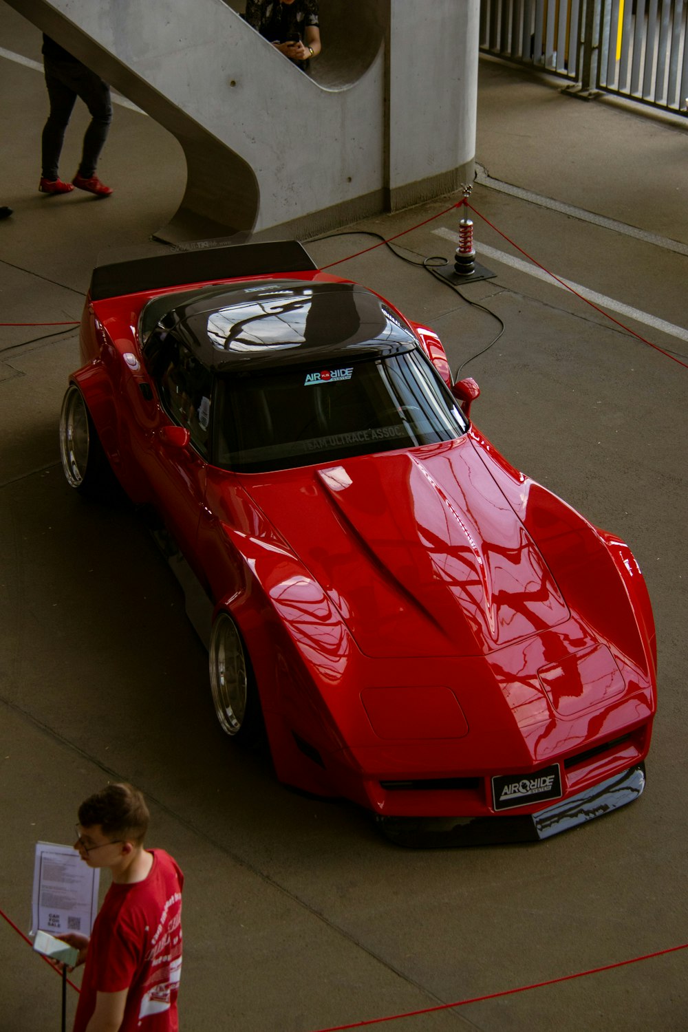 a red sports car parked in a parking lot