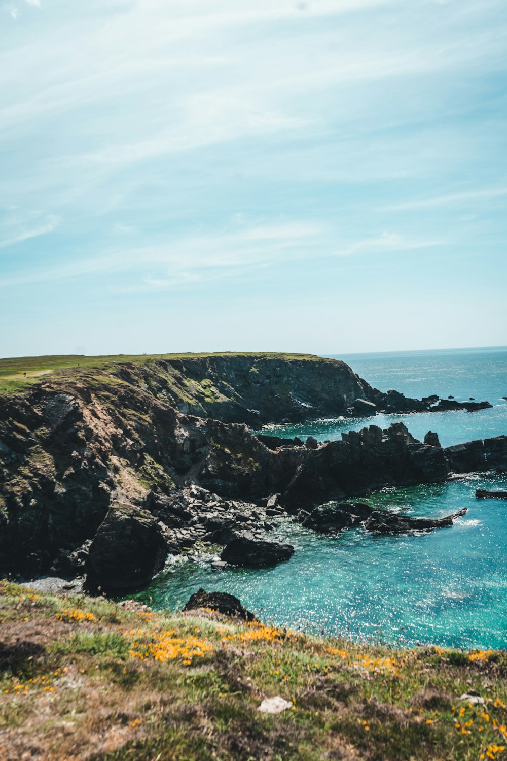 a body of water sitting on top of a lush green hillside