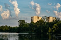 A serene landscape showcasing luxury properties and financial growth symbols.