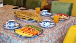 An inviting hotel dining area with tables set for breakfast.
