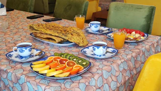 A vibrant breakfast spread in a hotel dining area with bold blue table settings and earthy tones.