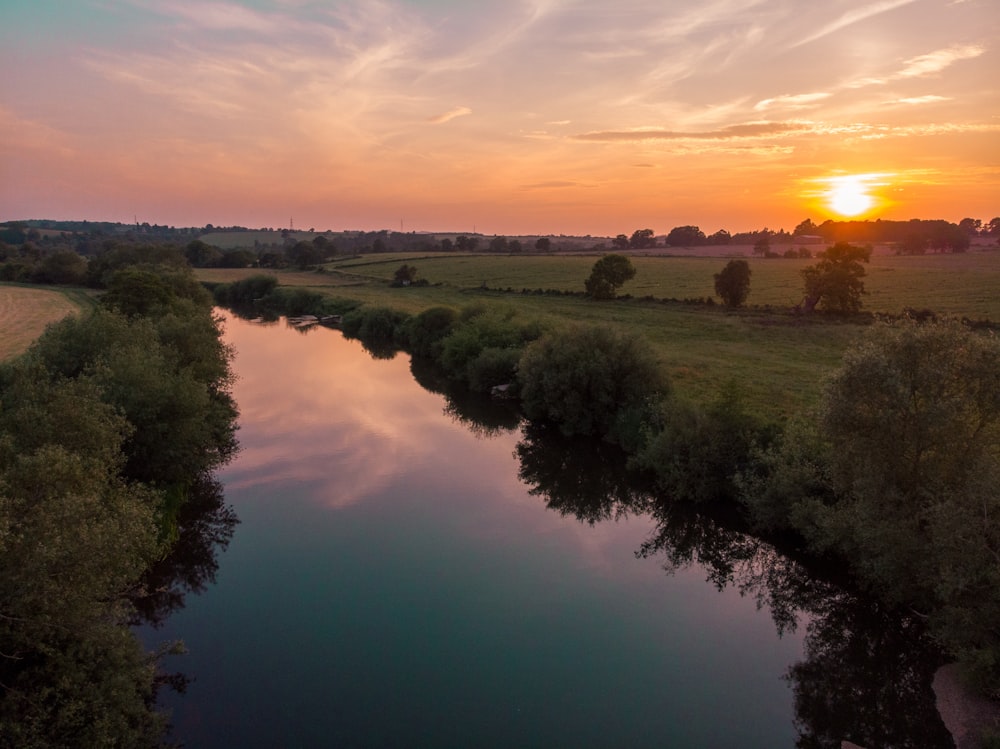 a river running through a lush green countryside