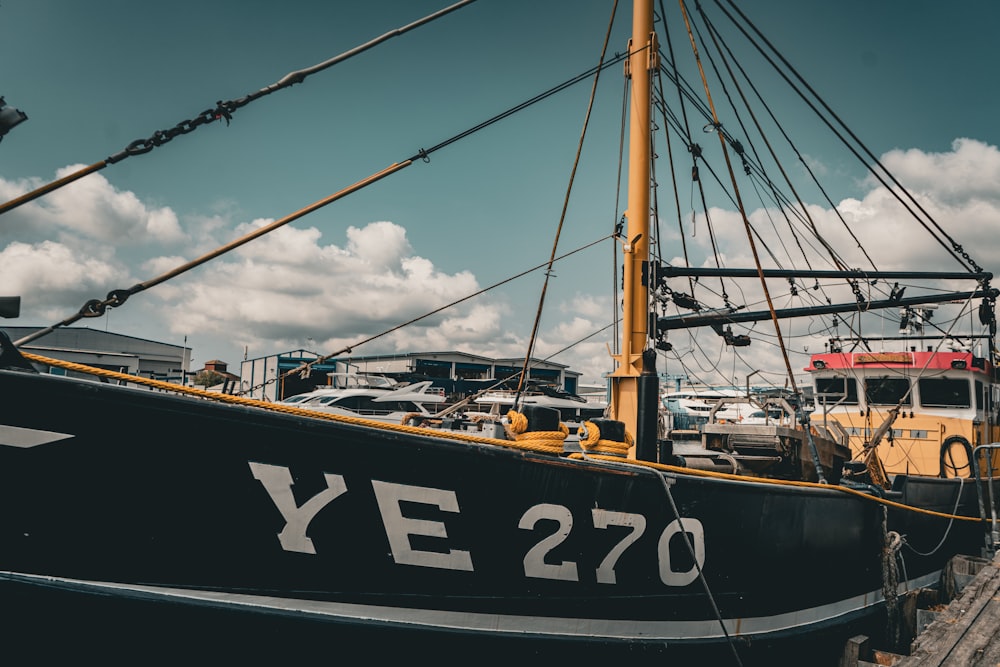 a black and white boat docked at a dock