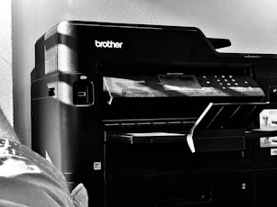 Monthly maintenance technician performing printer checkup and software updates.