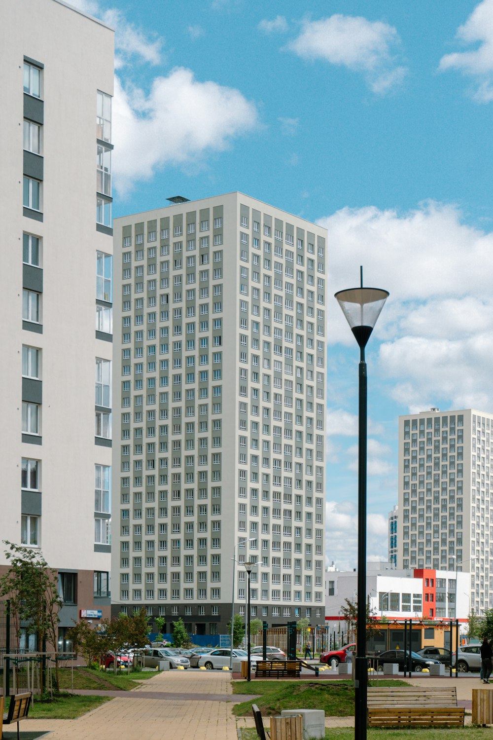 a street light sitting next to a tall white building