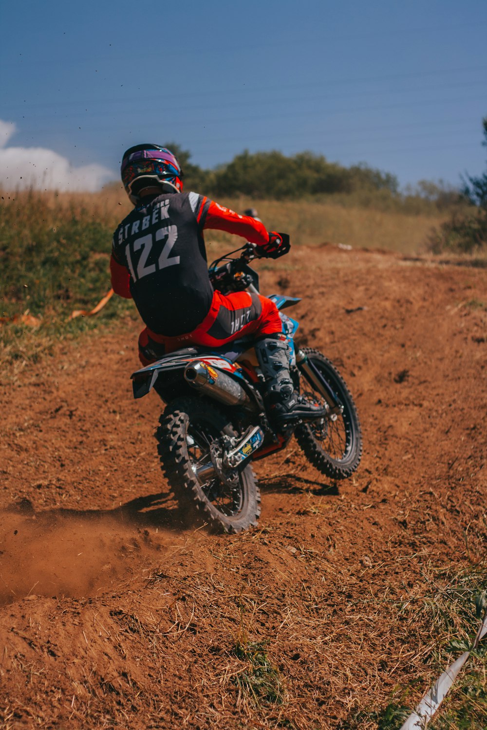 a person riding a dirt bike on a dirt track