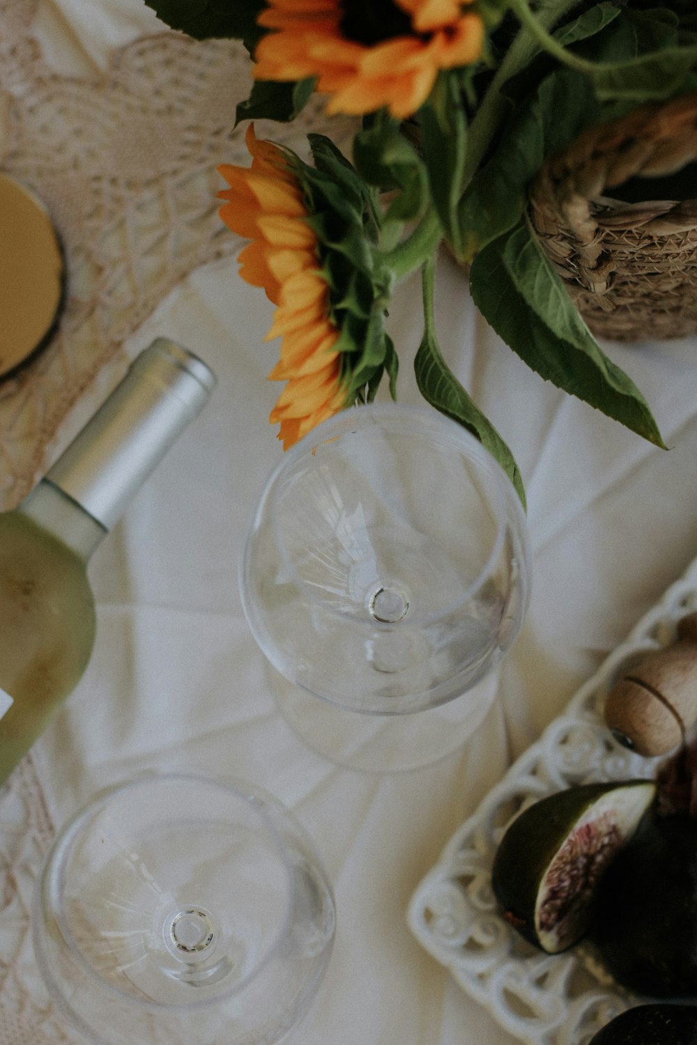 a table topped with two wine glasses and a vase filled with flowers