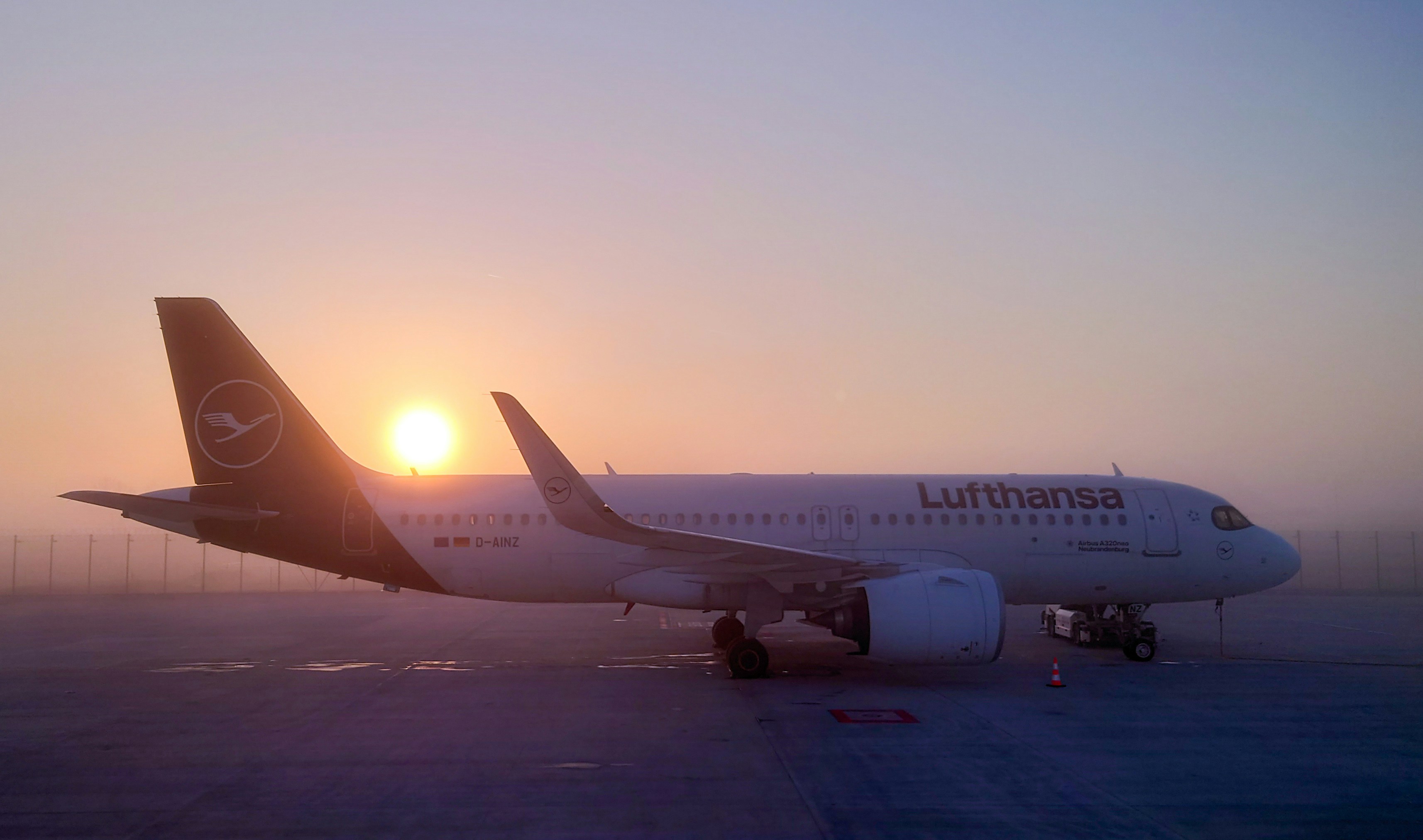 a large jetliner sitting on top of an airport tarmac, 