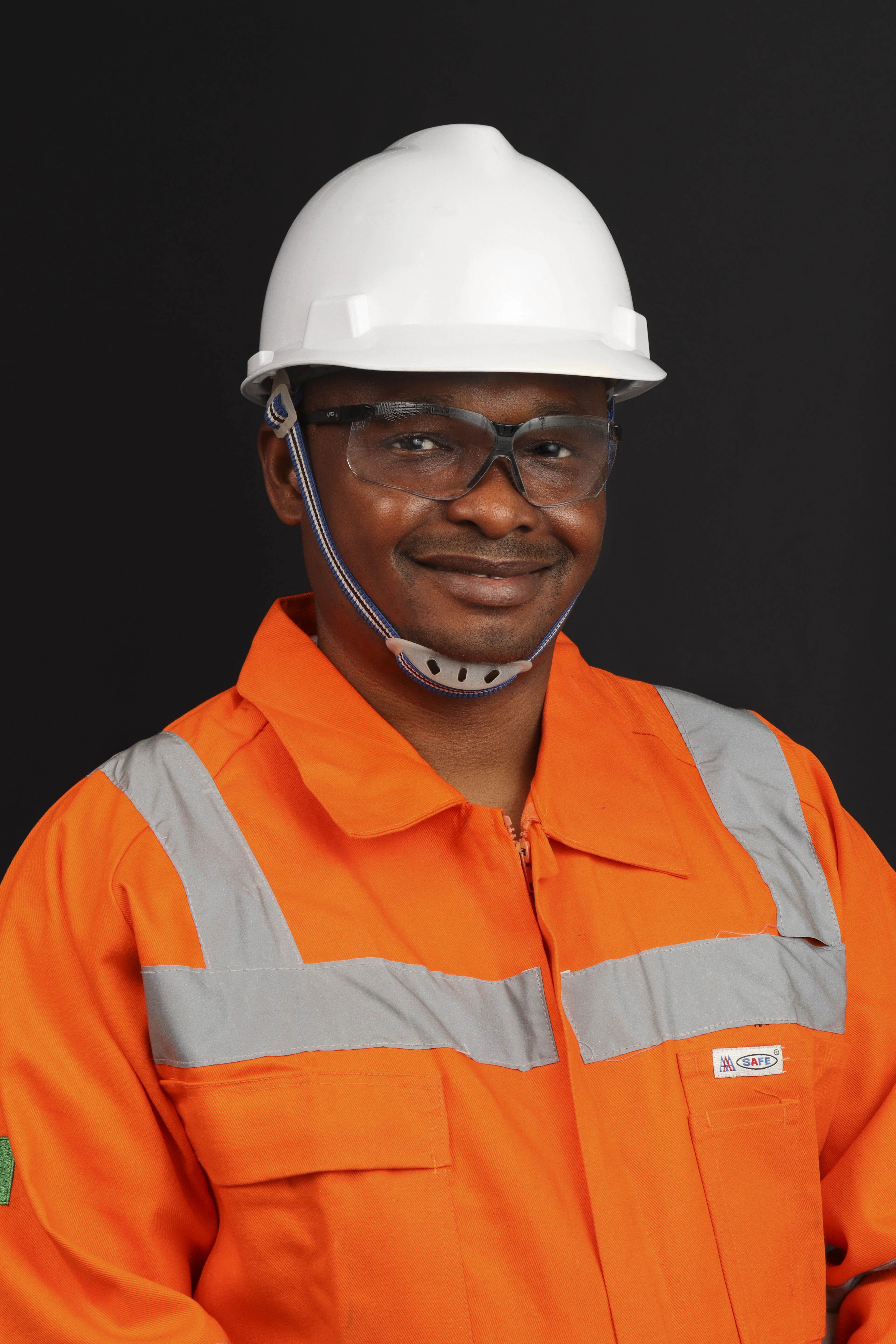 Smiling technician in hard hat and coveralls