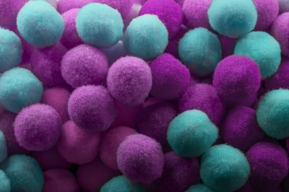 a pile of purple and blue pom poms