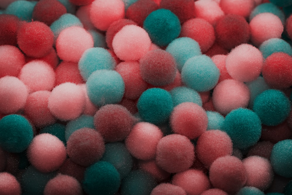 a pile of pink and blue pom poms