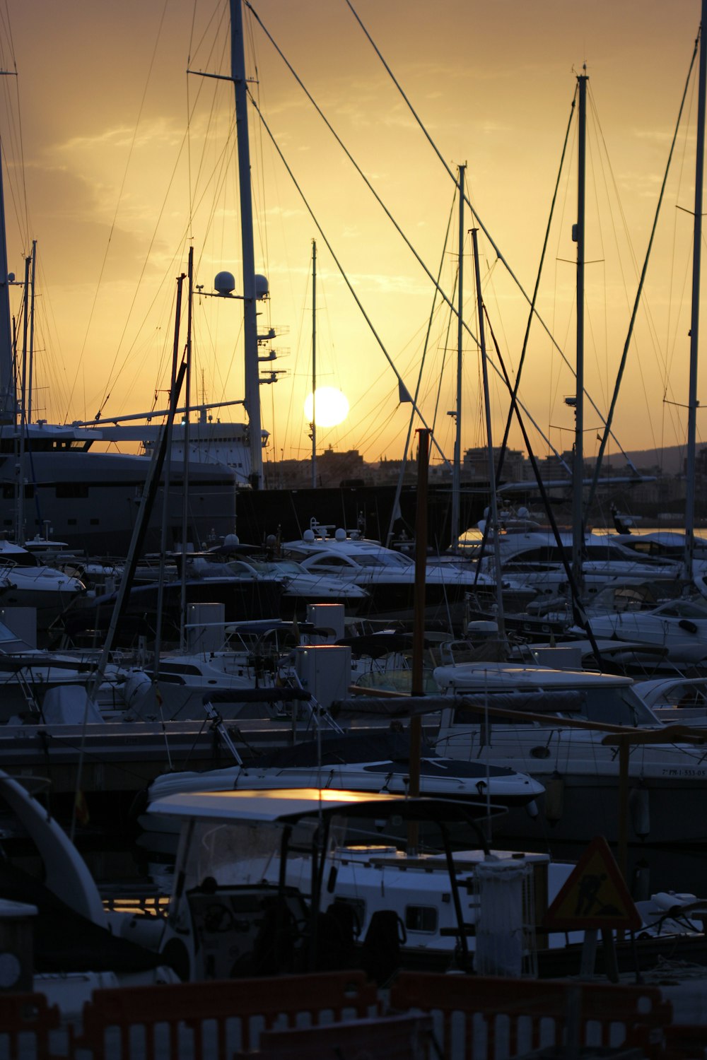 a harbor filled with lots of boats at sunset