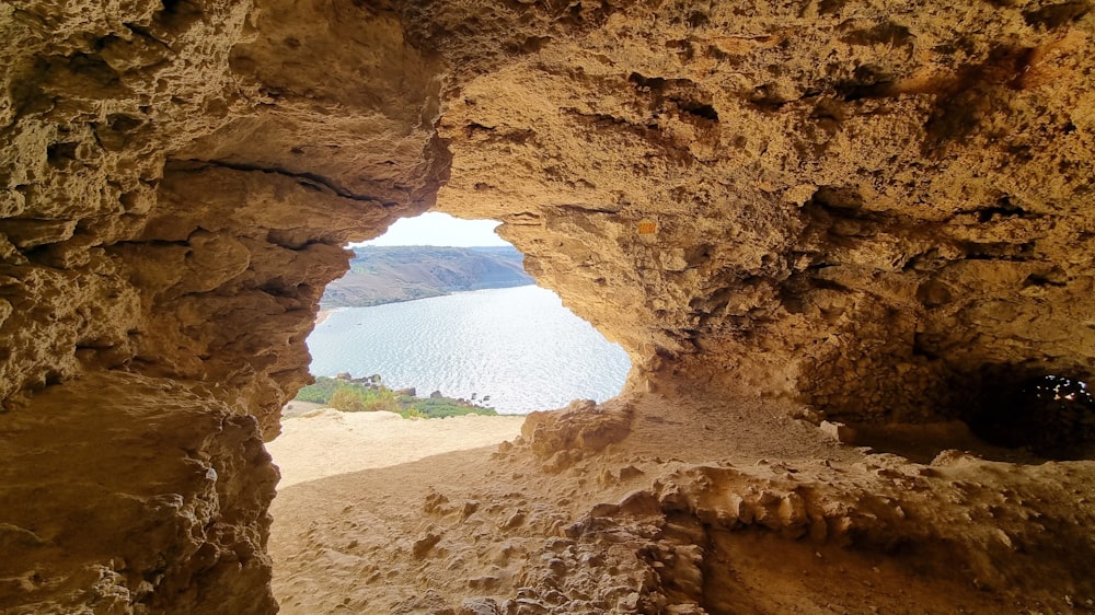a view of a body of water through a cave