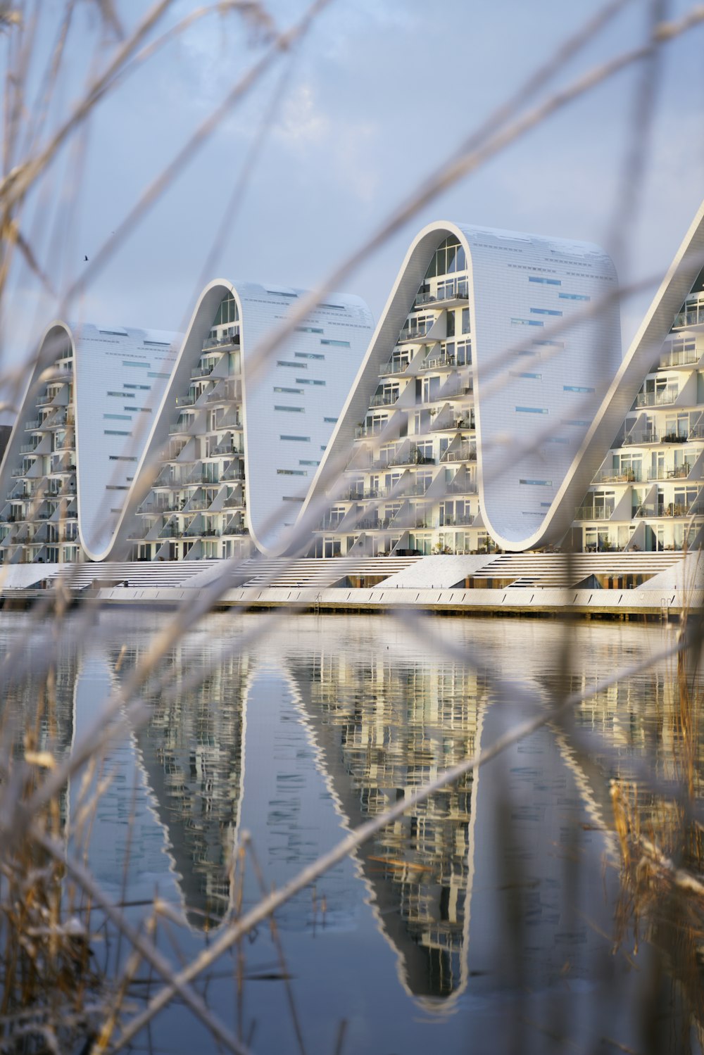 a row of buildings sitting next to a body of water