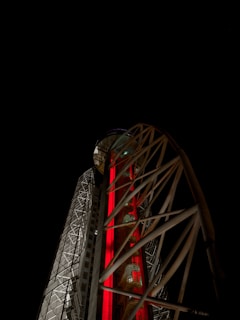 A sleek outdoor tower light illuminating a modern building facade at dusk.