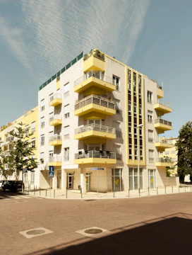a yellow and white building with balconies and balconies