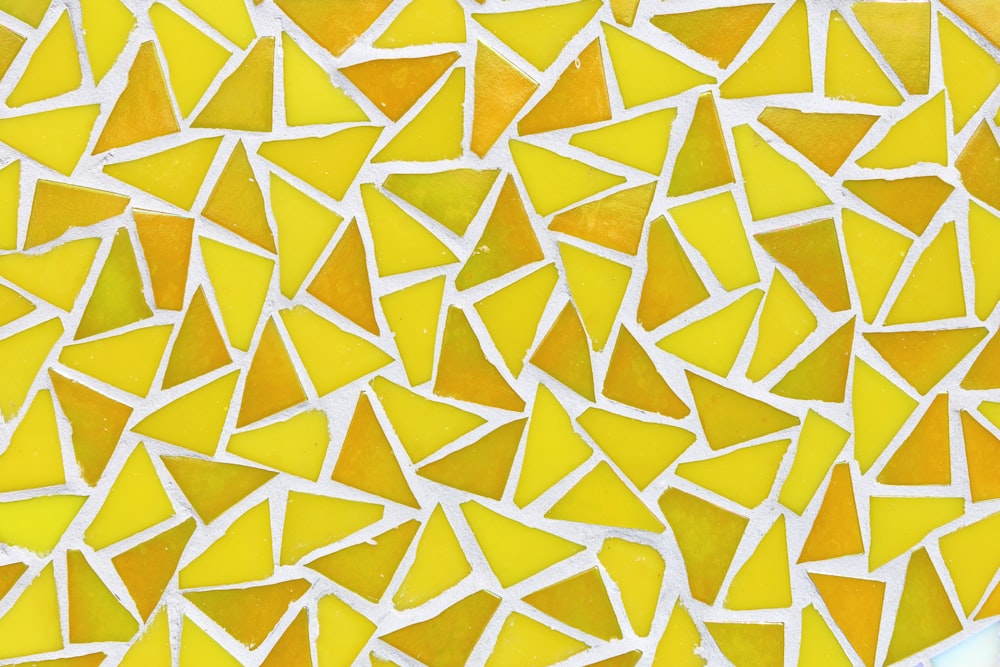 a close up of a yellow and white mosaic tile