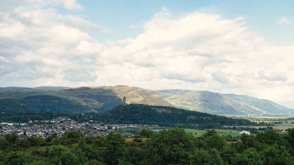 a scenic view of a town in the mountains