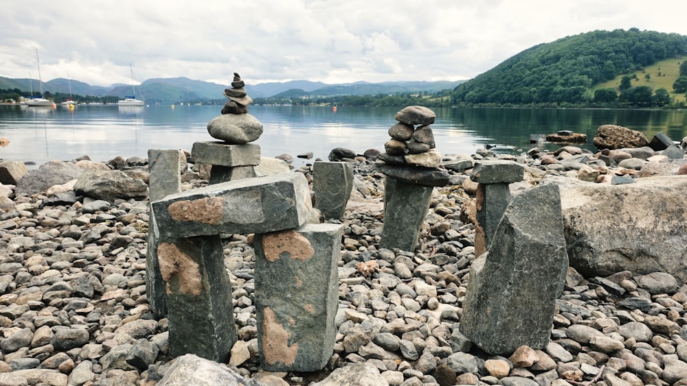 rocks stacked on top of each other near a body of water