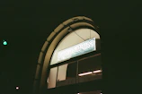 Night view of a lit-up window graphic highlighting a business logo.