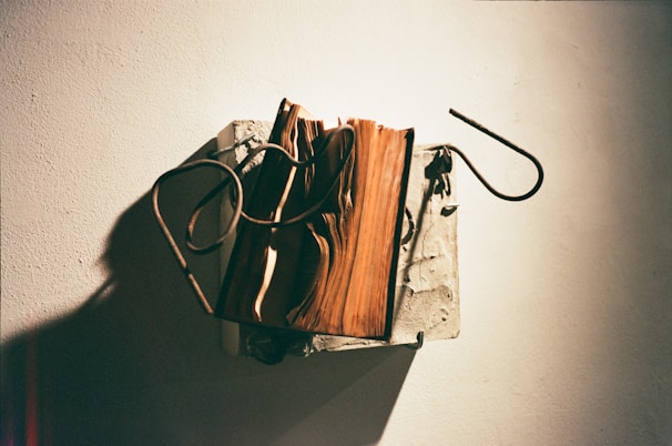 Sculptural wall hanging blending metal and wood with dynamic textures.