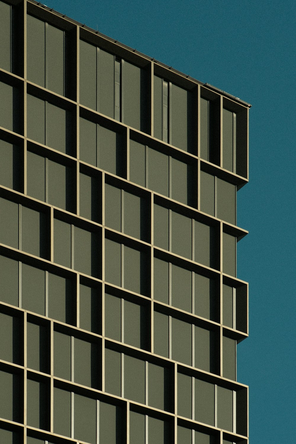 an airplane flying in the sky near a building