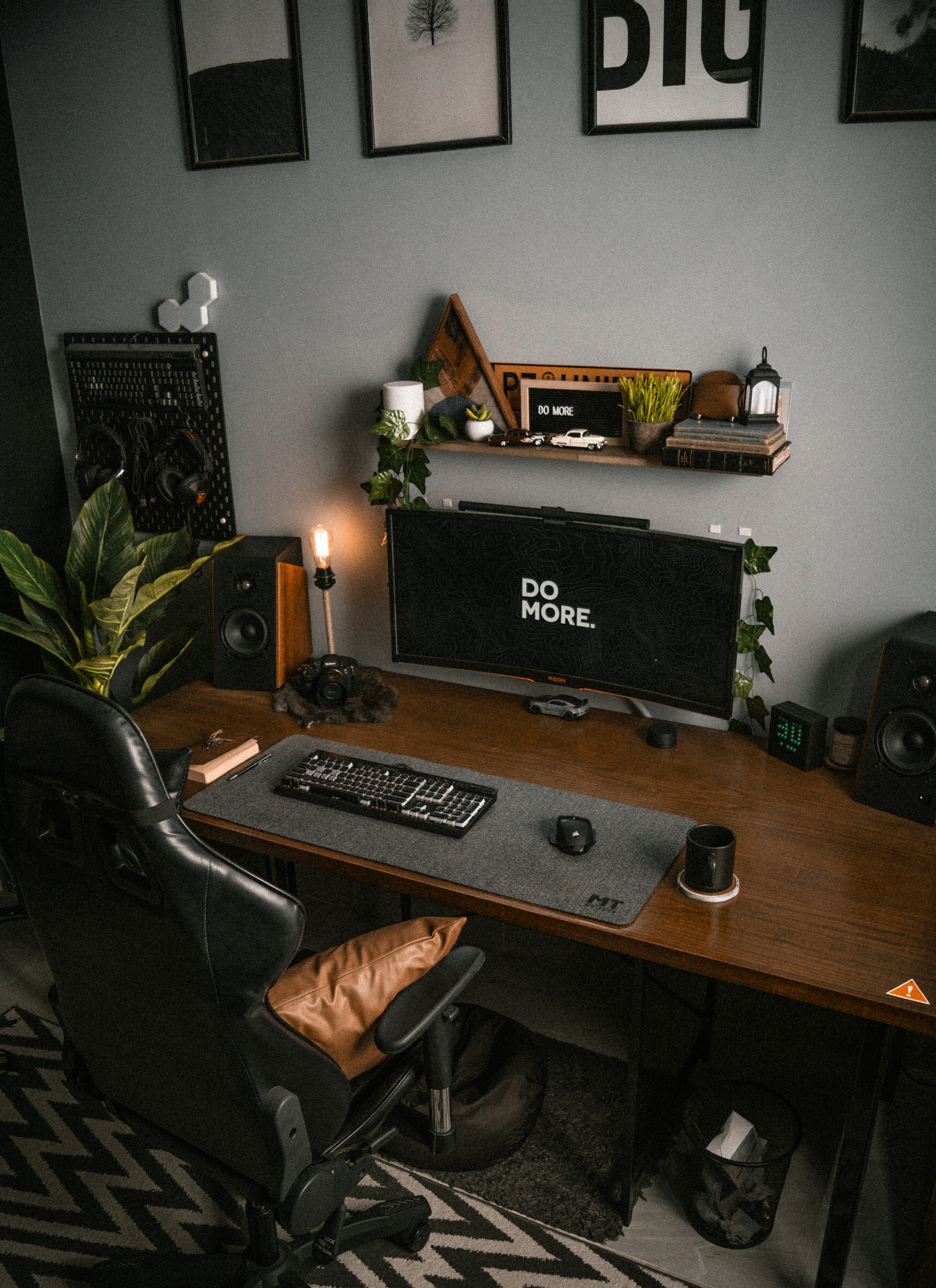 a desk with a computer and speakers on it