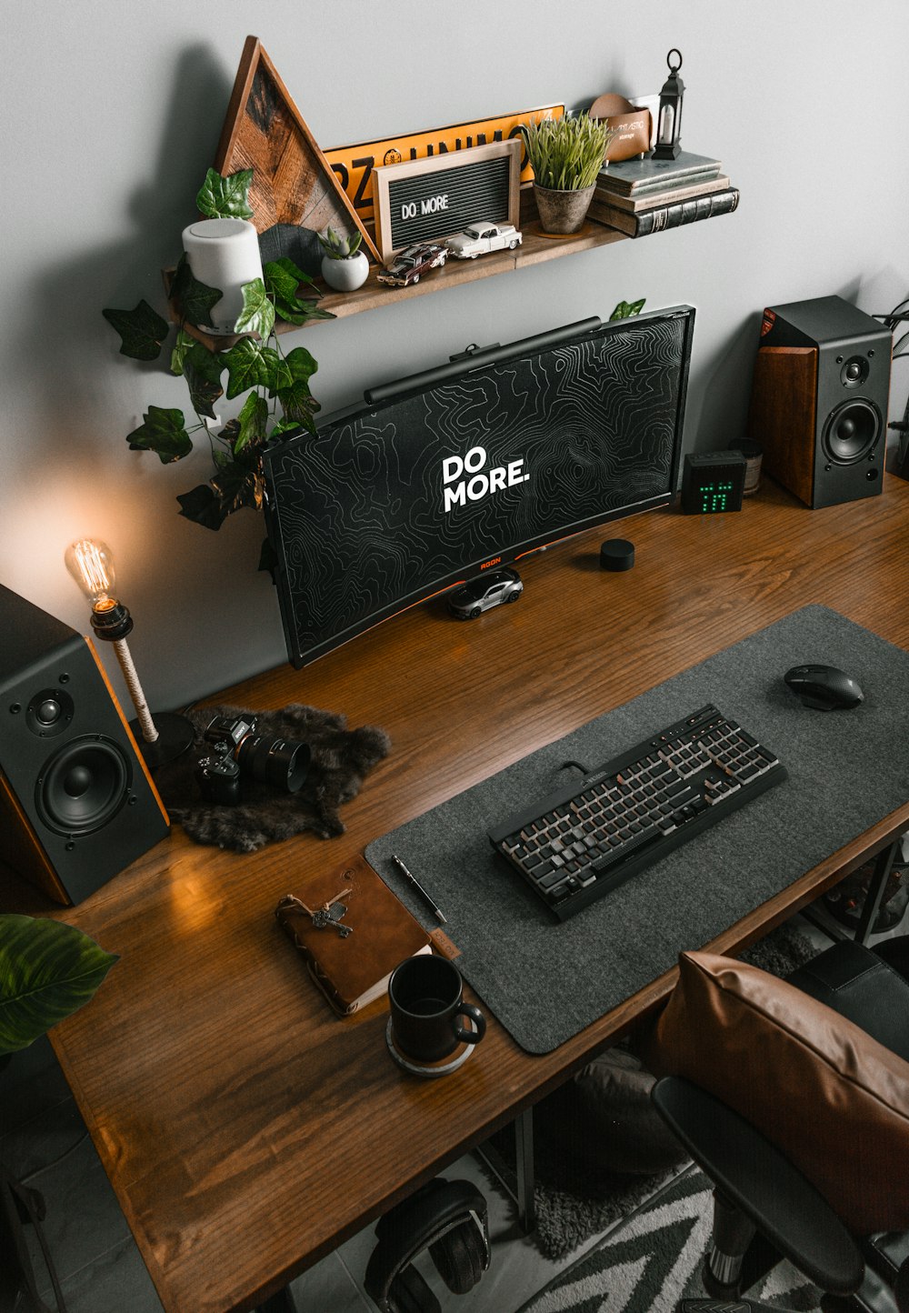 a computer desk with a keyboard and speakers