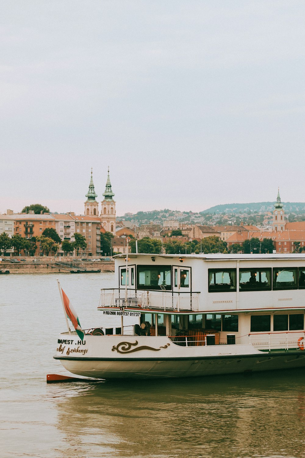 a large white boat floating on top of a river