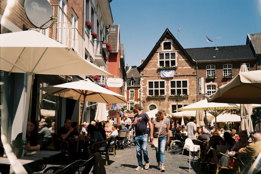 a group of people sitting at tables outside of a building