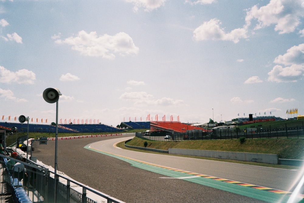 a view of a race track from behind a fence